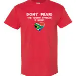 A bright red T-shirt with “Don’t Fear! The South African is Here!” text and a heart-shaped South African flag.
