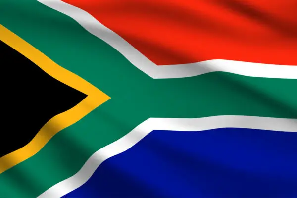 A close-up digital rendering of the South African flag with a fabric-like waving effect, creating a bold and dynamic look.