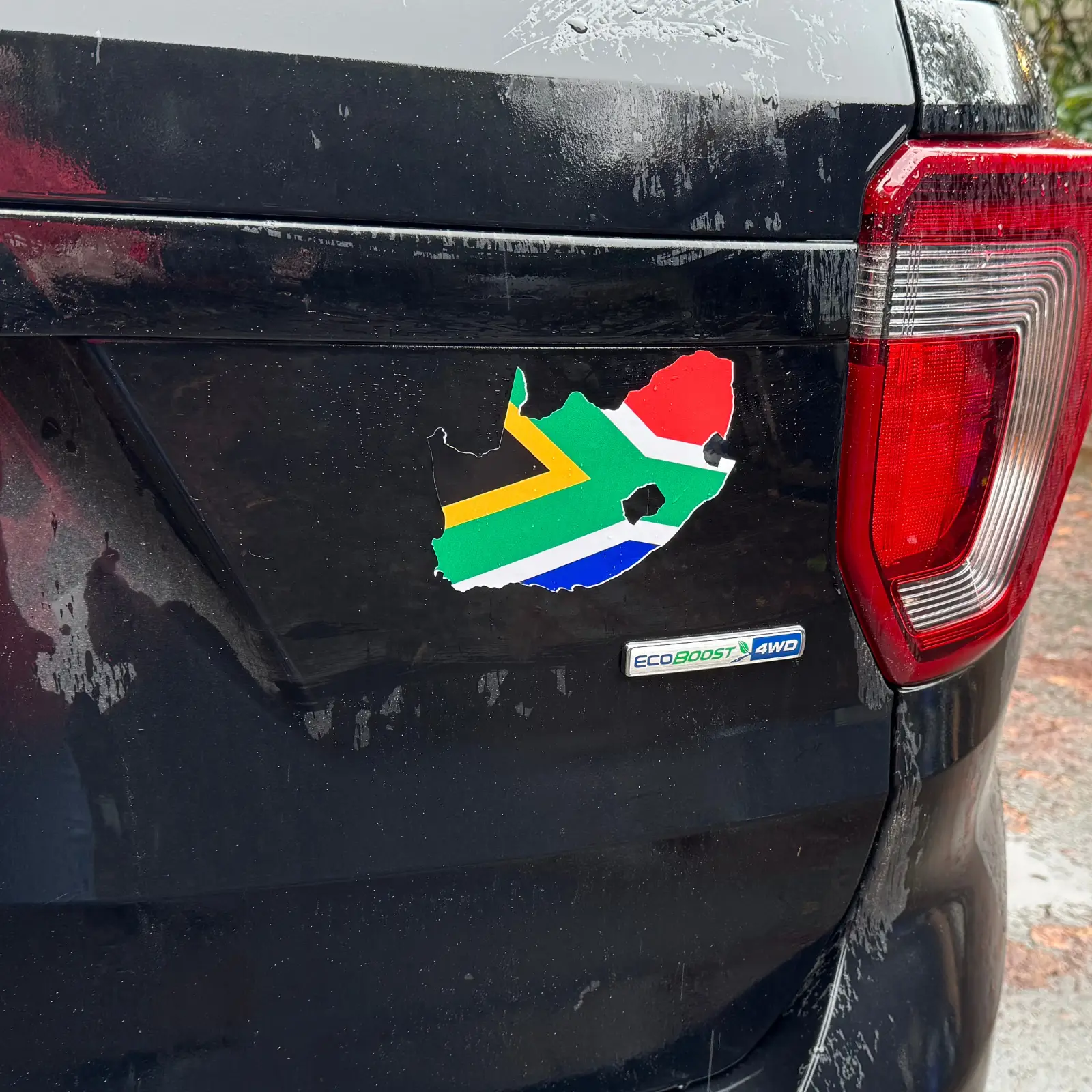 South Africa map sticker with the national flag inside, applied to the back of a black SUV.