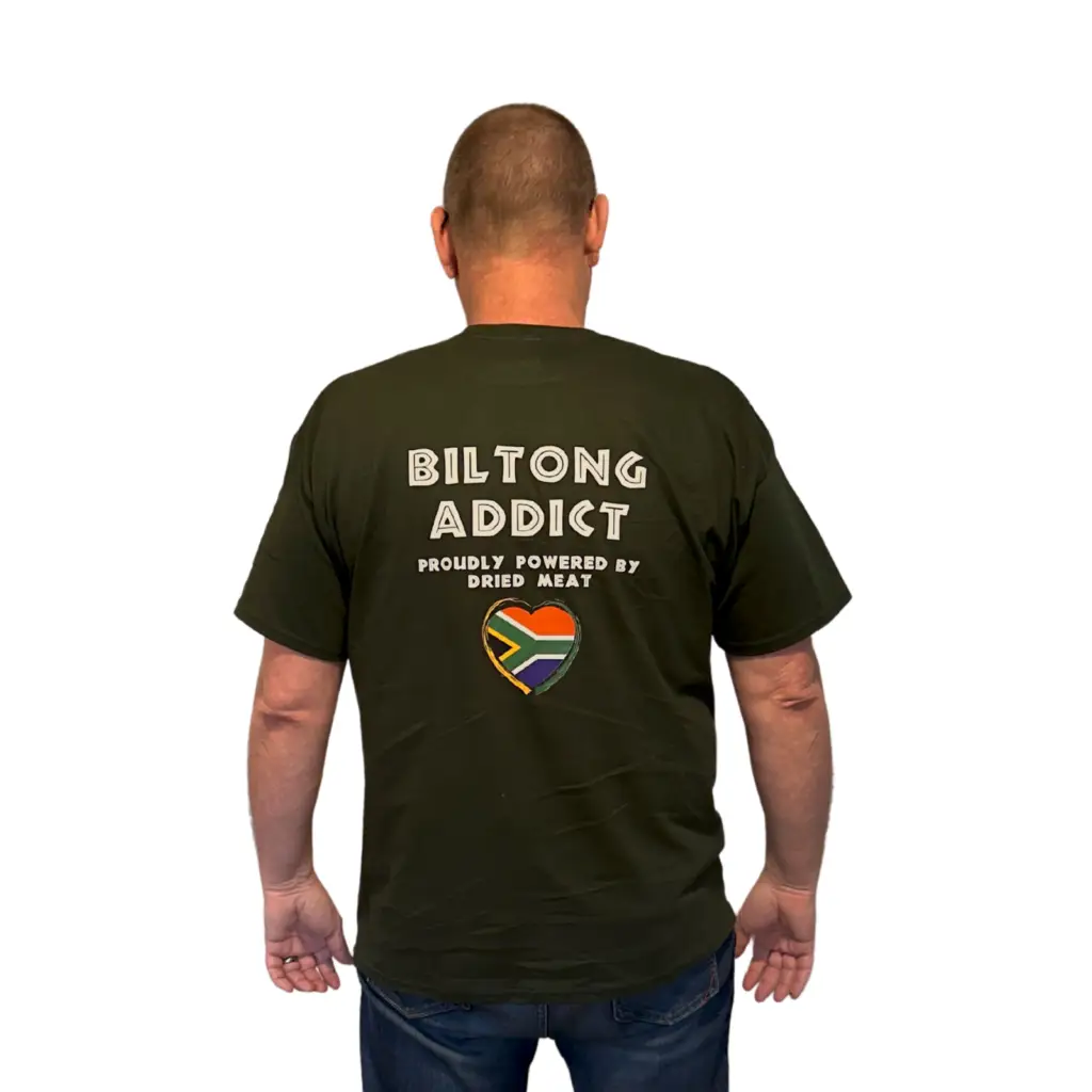 Back view of a man wearing a black Biltong Addict T-shirt featuring bold white text and a South African flag heart design.