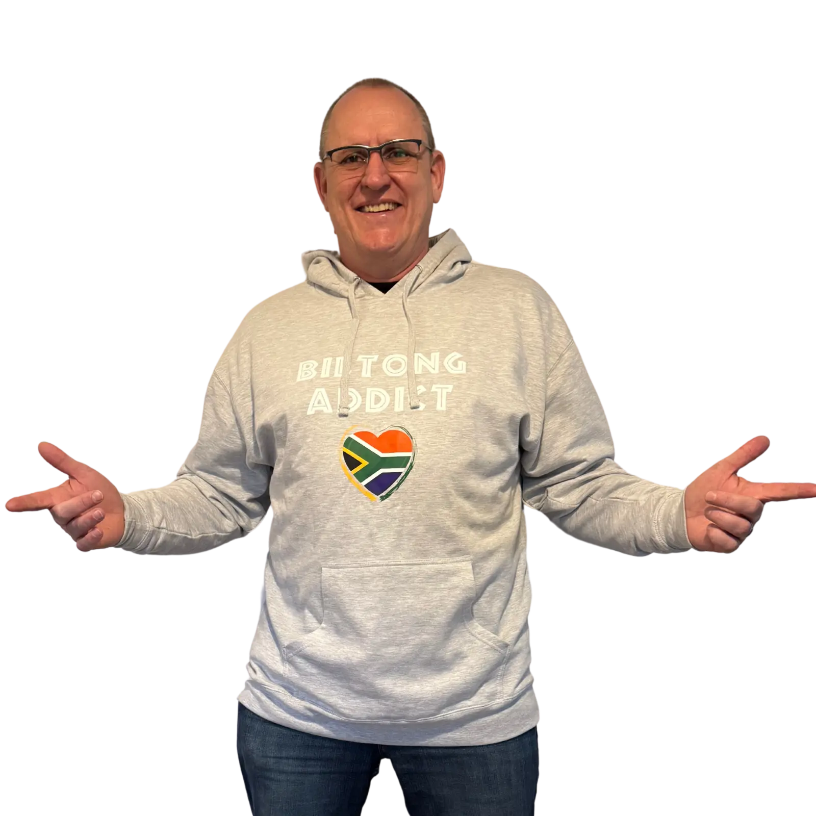 Man wearing a gray Biltong Addict hoodie, smiling and pointing at the design featuring bold text and a South African flag heart.