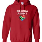 A red hoodie with “Biltong Addict” text and a heart-shaped South African flag on the front.